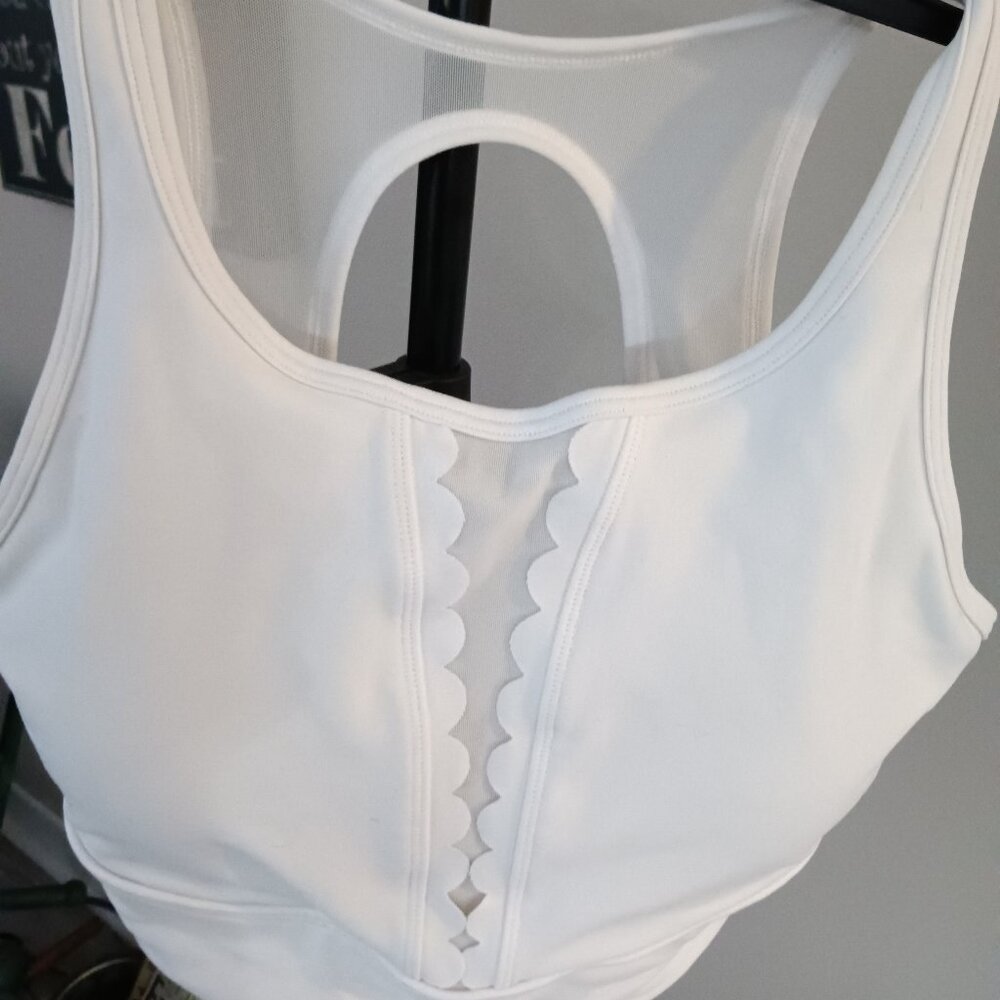 A preowned CALIA sports bra in pure white with extra coverage and detail.